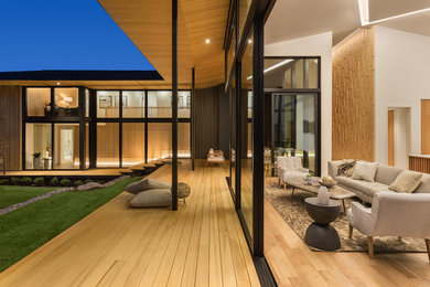 Example of a huge trendy open concept light wood floor living room design in Portland