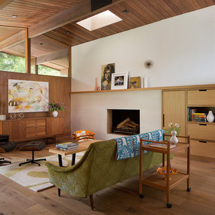 Living room - 1950s open concept medium tone wood floor and brown floor living room idea in San Francisco with white walls, a two-sided fireplace and a tile fireplace