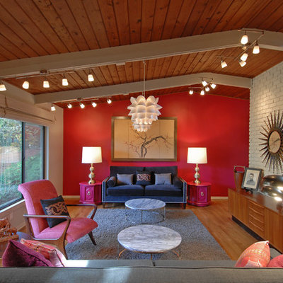 Minimalist medium tone wood floor living room photo in Atlanta with red walls, no fireplace and no tv
