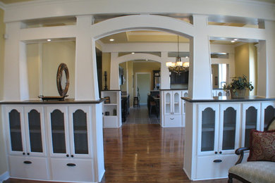 Example of a mid-sized classic enclosed laminate floor and brown floor living room design in Other with yellow walls and no tv