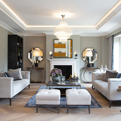 Living room - contemporary formal light wood floor living room idea in London with gray walls, a standard fireplace and no tv