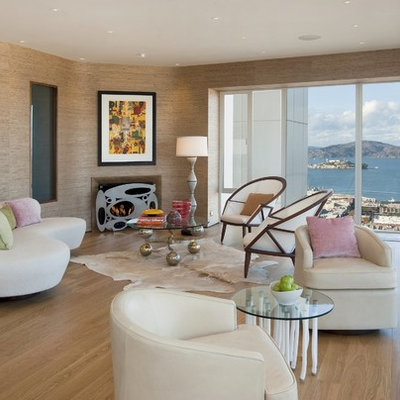 Example of a mid-sized trendy formal and enclosed light wood floor and brown floor living room design in San Francisco with beige walls, no tv, a standard fireplace and a plaster fireplace