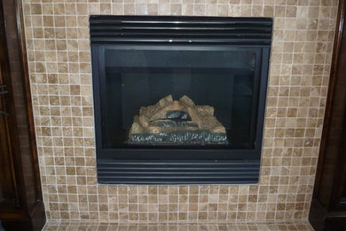 Living room in Omaha with a standard fireplace and a tiled fireplace surround.