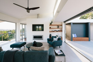 Diseño de salón abierto minimalista grande sin chimenea con paredes blancas, televisor colgado en la pared y suelo gris