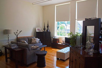Small transitional loft-style light wood floor living room photo in Burlington with white walls