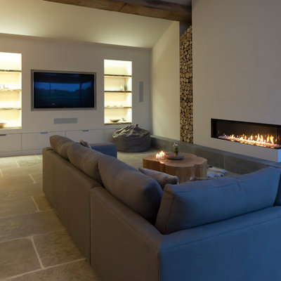 Example of a large trendy open concept limestone floor living room design in Cheshire with white walls, a corner fireplace and a plaster fireplace