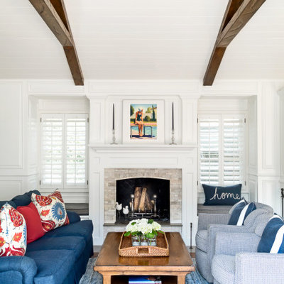 Living room - mid-sized traditional formal and open concept exposed beam and wainscoting living room idea in Los Angeles with white walls, a standard fireplace, a stone fireplace and no tv