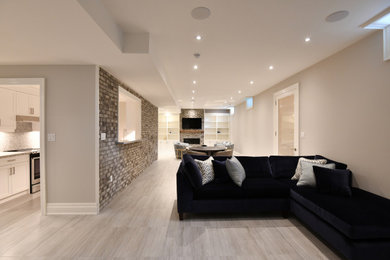 Mid-sized minimalist open concept ceramic tile and beige floor living room photo in Toronto with a bar, beige walls, a standard fireplace, a brick fireplace and a wall-mounted tv