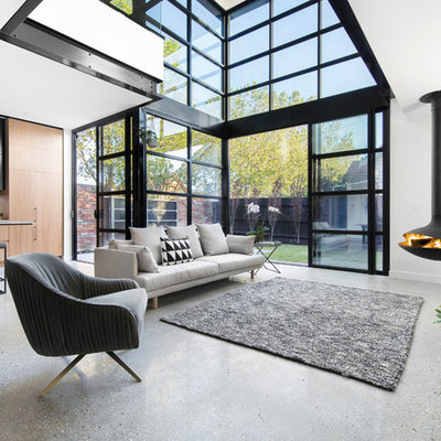 Living room - contemporary open concept living room idea in Melbourne with white walls and a hanging fireplace