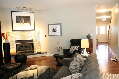 Example of a mid-sized transitional formal and open concept dark wood floor and brown floor living room design in Bridgeport with white walls, a corner fireplace, a tile fireplace and no tv