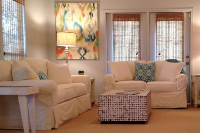 This is an example of a coastal living room in New Orleans with grey walls.