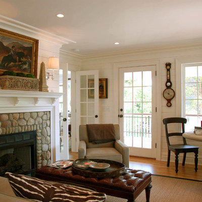 Example of a mid-sized beach style formal and enclosed medium tone wood floor living room design in New York with a stone fireplace, white walls and a standard fireplace