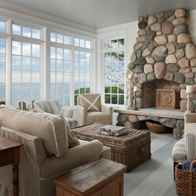 Mid-sized beach style enclosed painted wood floor living room photo in Other with white walls, a standard fireplace and a stone fireplace