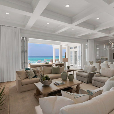 Huge beach style open concept light wood floor living room photo in Miami with white walls, a standard fireplace, a tile fireplace and a wall-mounted tv