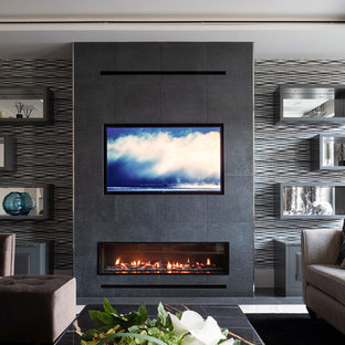 Inspiration for a medium sized contemporary open plan living room in Hertfordshire with black walls, porcelain flooring, a ribbon fireplace, a metal fireplace surround, white floors and a built-in media unit.