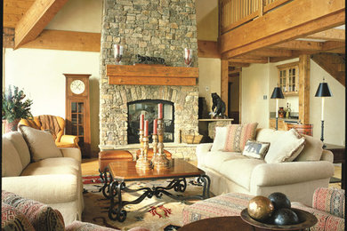 Inspiration for a large rustic formal and open concept carpeted living room remodel in Other with beige walls, a standard fireplace, a stone fireplace and no tv