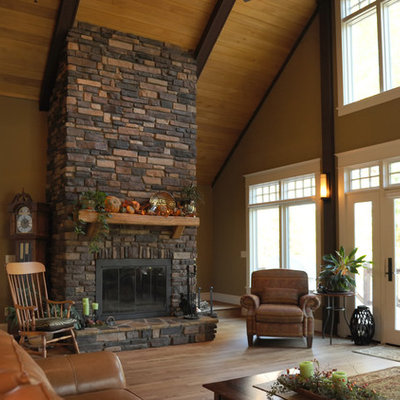Living room - mid-sized traditional formal and open concept light wood floor living room idea in Other with beige walls, a standard fireplace and a stone fireplace
