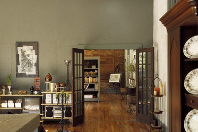 Example of a classic brown floor living room design in Jackson with green walls