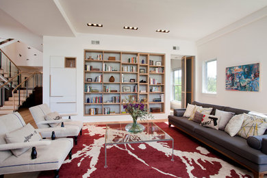 Example of a trendy open concept living room design in Other with white walls