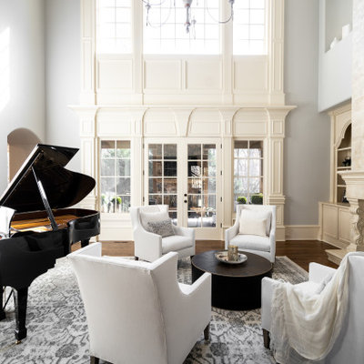 Example of a classic enclosed medium tone wood floor and brown floor living room design in Atlanta with a music area, brown walls, a standard fireplace and no tv