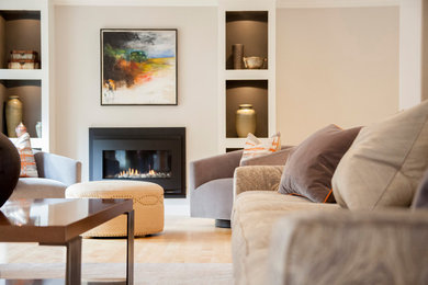 Inspiration for a medium sized contemporary open plan living room in Melbourne with grey walls, light hardwood flooring, a standard fireplace and a plastered fireplace surround.