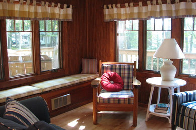 Living room - mid-sized traditional formal and enclosed medium tone wood floor living room idea with brown walls, no fireplace and a tv stand