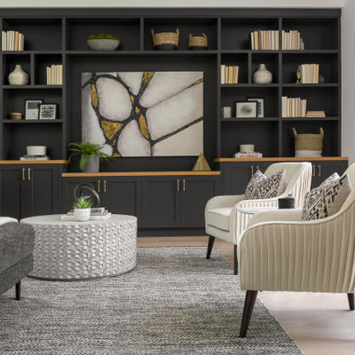 Large transitional formal and open concept light wood floor and beige floor living room photo in Los Angeles with black walls, a media wall and no fireplace
