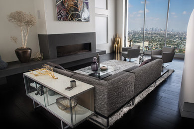 Example of a huge trendy formal and loft-style dark wood floor living room design in Los Angeles with gray walls, a ribbon fireplace, a concrete fireplace and no tv