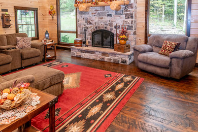 Inspiration for a rustic formal and loft-style medium tone wood floor and brown floor living room remodel in Other with a standard fireplace and a stone fireplace