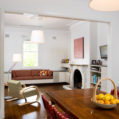Living room - mid-sized modern formal and open concept dark wood floor living room idea in Sydney with white walls, a standard fireplace, a stone fireplace and no tv