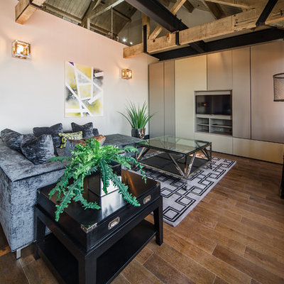 Example of an urban medium tone wood floor and brown floor living room design in West Midlands with red walls and a media wall