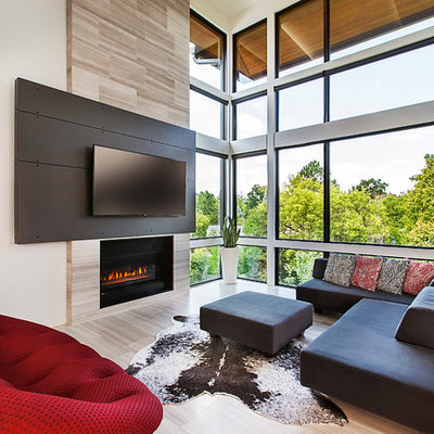Inspiration for a mid-sized contemporary open concept light wood floor living room remodel in Detroit with a standard fireplace, a wall-mounted tv and beige walls