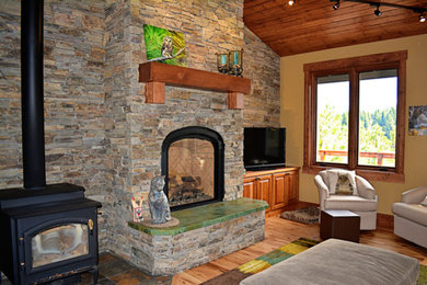 Mid-sized mountain style open concept light wood floor living room photo in Boise with yellow walls, a standard fireplace, a brick fireplace and a tv stand