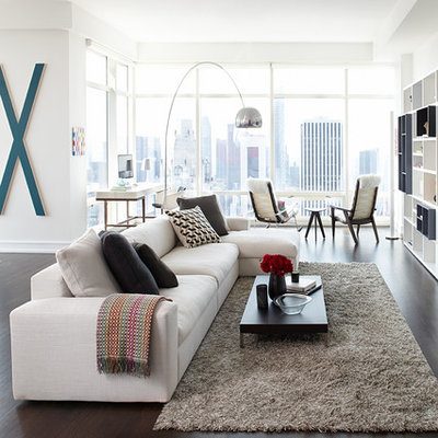 Large trendy open concept dark wood floor and brown floor living room photo in Other with white walls, no fireplace and a media wall