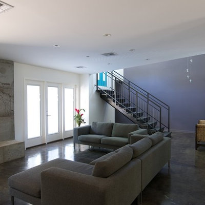 Example of a trendy living room design in Houston with blue walls and a concrete fireplace