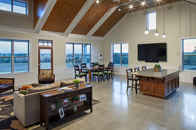 Example of a large trendy formal and open concept concrete floor and gray floor living room design in Austin with white walls and a wall-mounted tv