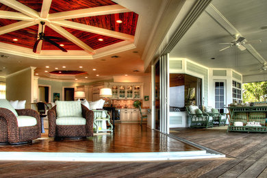 Example of a mid-sized transitional formal and open concept medium tone wood floor living room design in Tampa with green walls, a wall-mounted tv and no fireplace