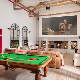 Photo of a large country living room in Wiltshire with multi-coloured walls, a wall mounted tv and multi-coloured floors.