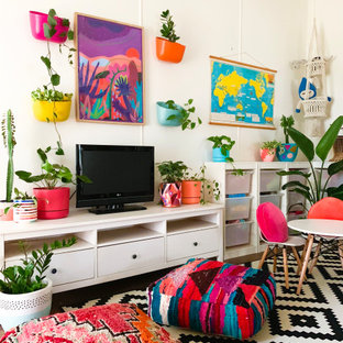 Photo of an eclectic living room in Melbourne with white walls and a freestanding tv.