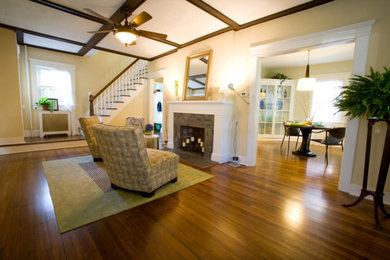Inspiration for a mid-sized transitional formal and enclosed medium tone wood floor and brown floor living room remodel in Boise with yellow walls, a standard fireplace, a tile fireplace and no tv