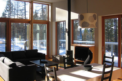 Example of a mid-sized classic open concept living room design in Seattle with beige walls, a wood stove and a metal fireplace