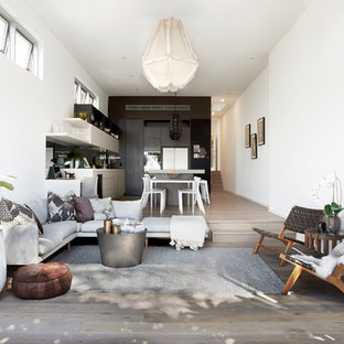 Inspiration for a small contemporary open concept living room in Sydney with white walls, light hardwood floors and brown floor.