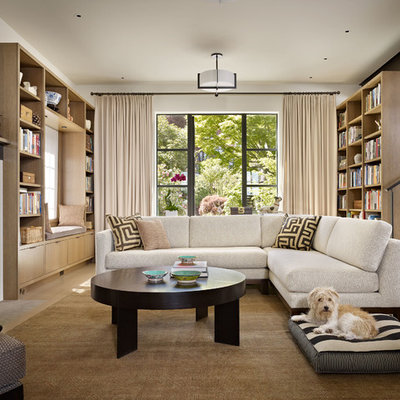 Living room library - contemporary light wood floor living room library idea in Seattle with white walls and a standard fireplace