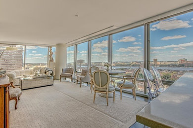 Modern formal open plan living room in Boston with beige walls.