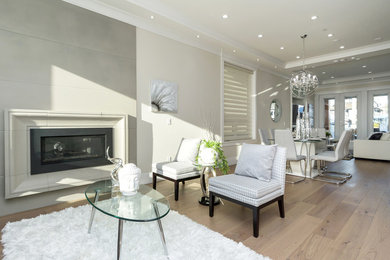 Modern formal enclosed living room in Vancouver with a standard fireplace and a concrete fireplace surround.