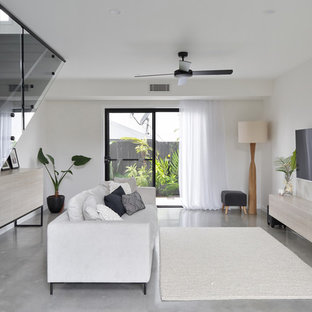 Mid-sized contemporary living room in Sunshine Coast with white walls, concrete floors and grey floor.