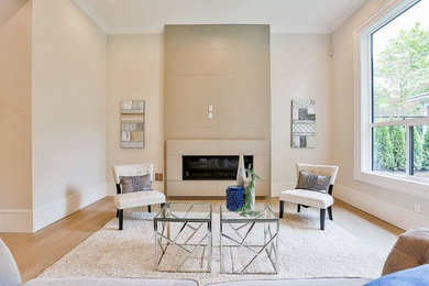 Example of a mid-sized minimalist formal and open concept ceramic tile and beige floor living room design in Vancouver with white walls, a ribbon fireplace, a metal fireplace and no tv