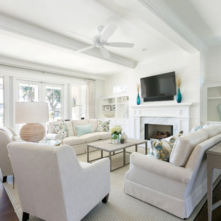 Example of a transitional open concept dark wood floor and brown floor living room design in Charleston with white walls, a standard fireplace, a stone fireplace and a wall-mounted tv