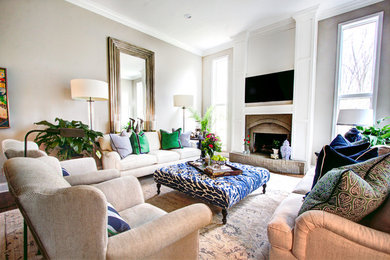 На фото: изолированная гостиная комната среднего размера в классическом стиле с белыми стенами, паркетным полом среднего тона, стандартным камином, фасадом камина из кирпича и телевизором на стене