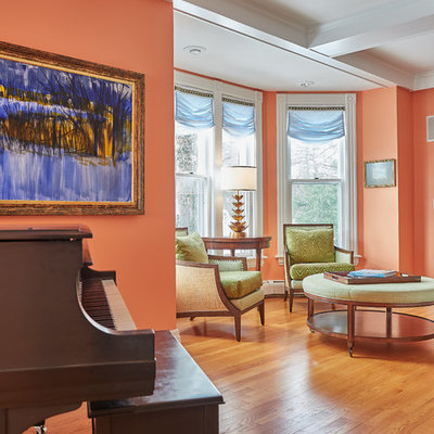 Example of a mid-sized classic formal and open concept medium tone wood floor and brown floor living room design in New York with orange walls, a standard fireplace, a tile fireplace and no tv